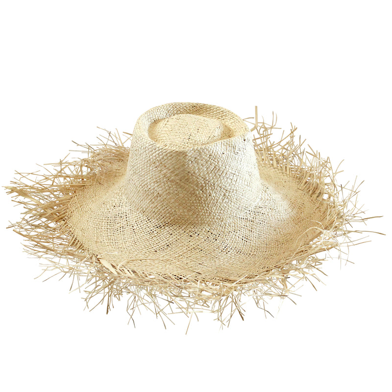 BrunnaCo Catalina Frayed Straw Hat. Meet Catalina, the timeless beauty, with an edge. Made entirely of straw, this mesmerizing sun hat has a wide brim and a frayed edge. Thoughtfully made by artisan communities in Java, from locally harvested straws. Wear it like a crown - with your resort dresses and swimsuits for a perfect romantic getaway.