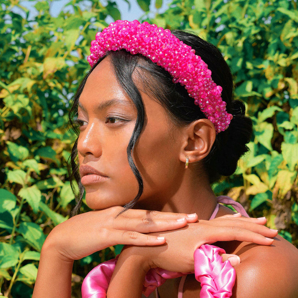 Add a touch of sparkle to your look with BrunnaCo’s  dazzling CROWN Glass Headband in hot pink color. The intricate glass beads arrangement catches the eye and sparkles with every movement, making it the perfect finishing touch for any special occasion.