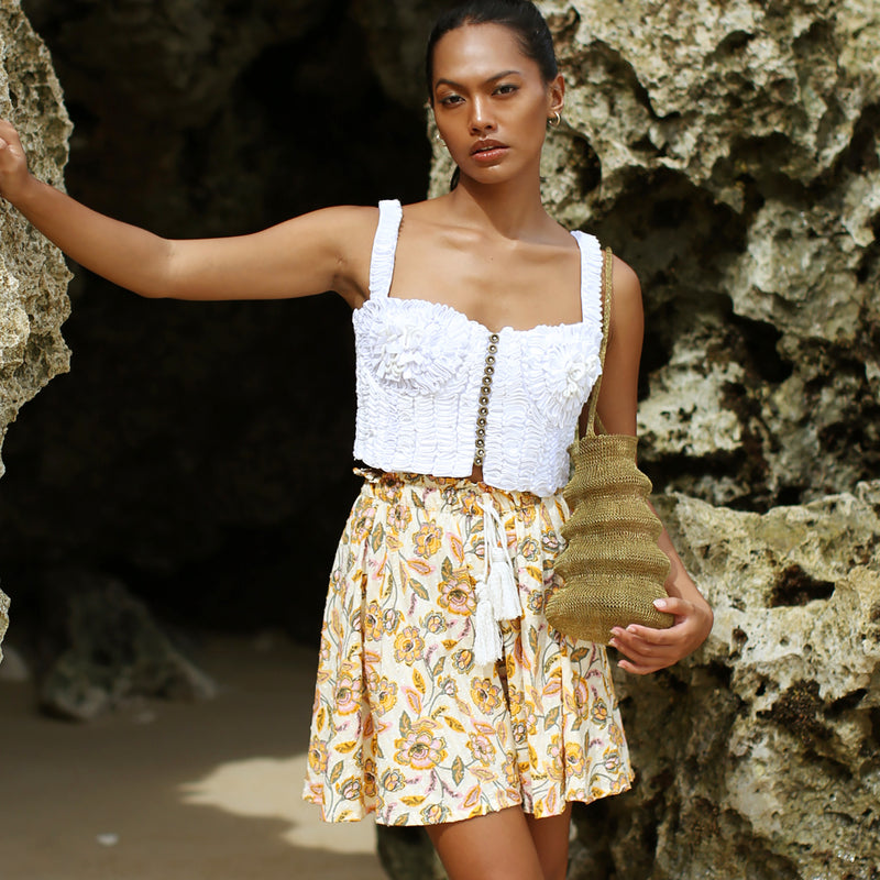 SEKAR Floral Batik Shorts is made entirely from a relaxed, lightweight cotton fabric fit for every warm-weather destination. With the drawstring waist, wear SEKAR both low and high-rise. As seen on our lookbook, style SEKAR with our MARIGOLD Hand-embroidered Bralette Top.