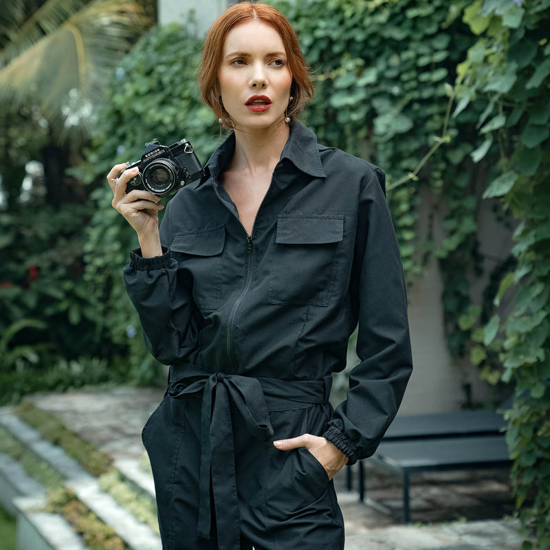 Our cool and casual Amelia Jumpsuit in black with its relaxed style is designed for the perfect traveling or outdoor occasion. Complete with a spread collar, tie waist, and front utility pockets, this chic jumpsuit offers a simple yet stylish look.