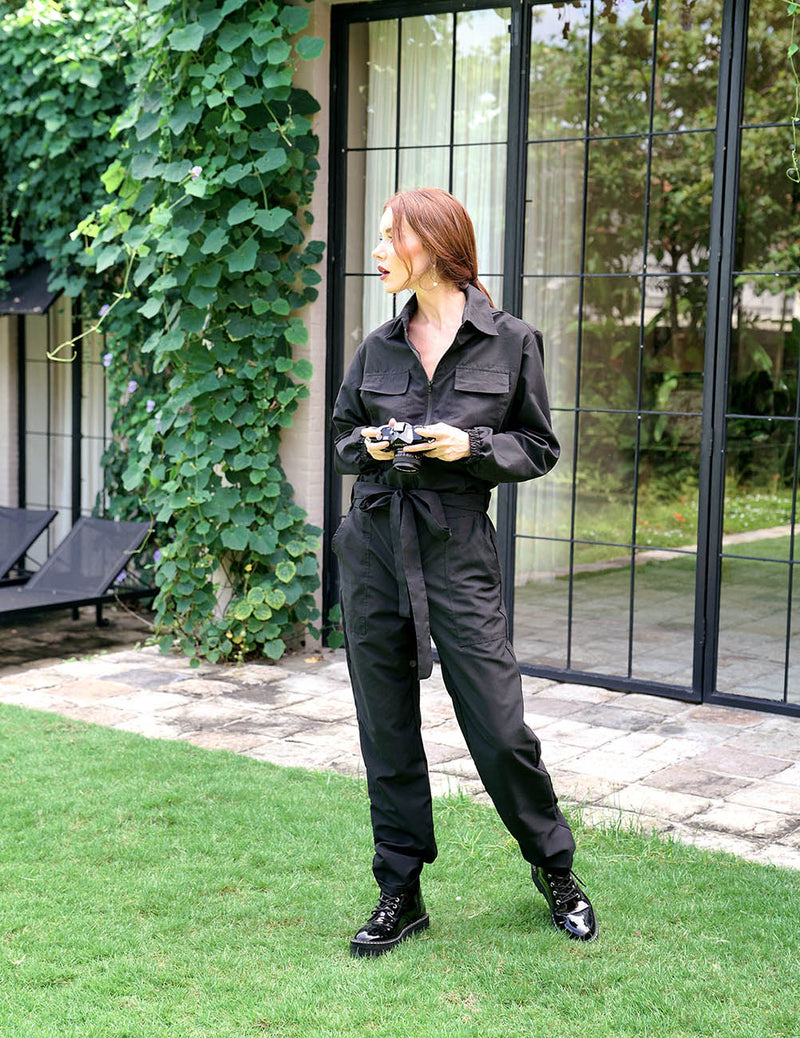 Our cool and casual Amelia Jumpsuit in black with its relaxed style is designed for the perfect traveling or outdoor occasion. Complete with a spread collar, tie waist, and front utility pockets, this chic jumpsuit offers a simple yet stylish look.