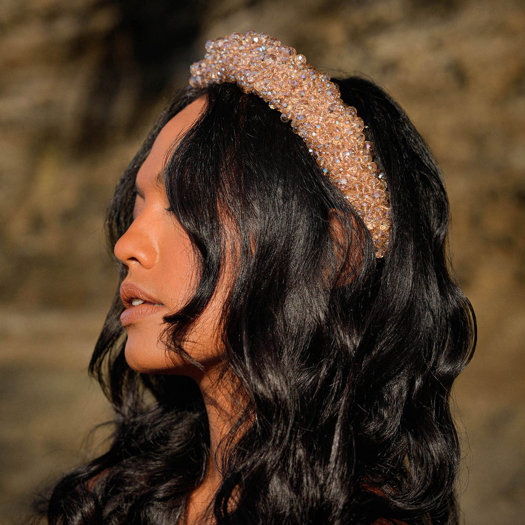 Add a touch of sparkle to your look with BrunnaCo’s dazzling CROWN Glass Headband in champagne beige color. The vibrant array of faceted glass beads catches the eye and sparkles with every movement, making it the perfect finishing touch for any special occasion.