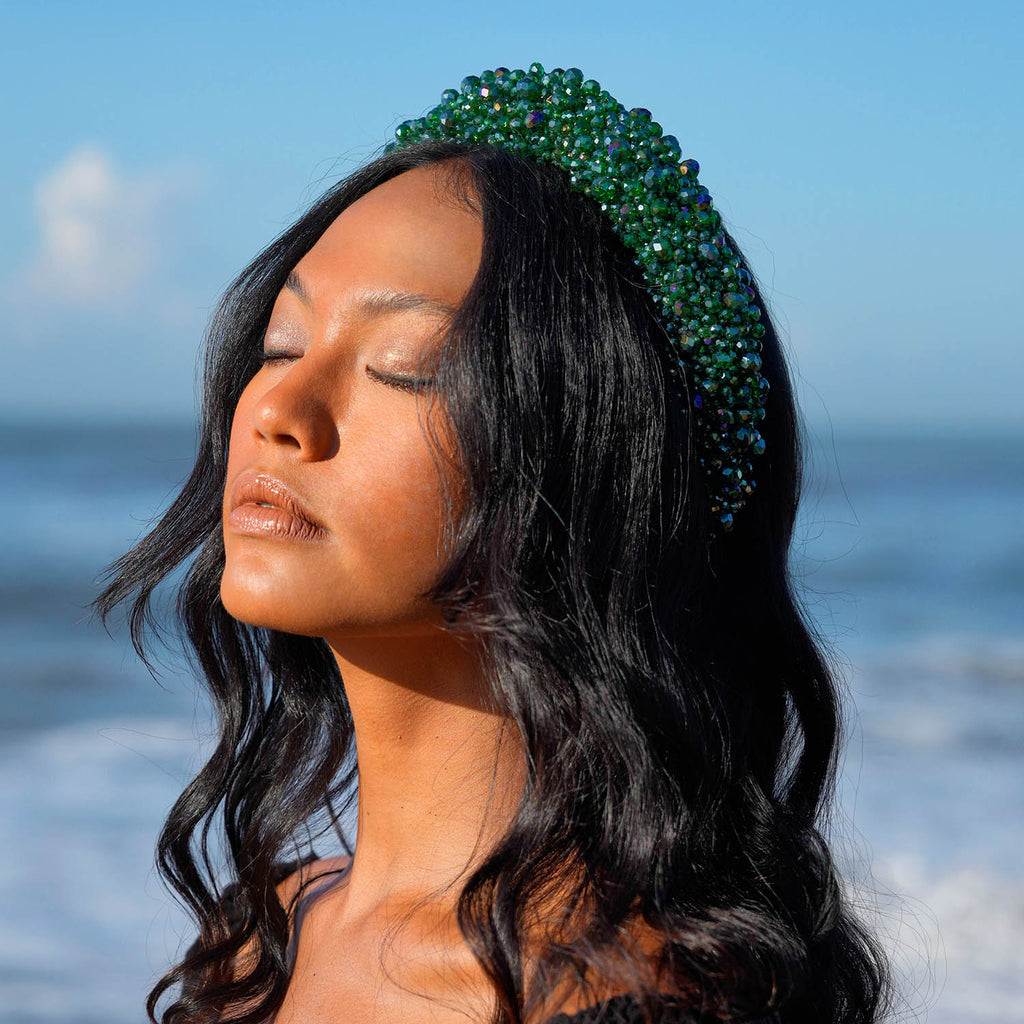 Take your look to the next level with BrunnaCo's exquisite CROWN Glass Crystal Headband. This stunning accessory features a lush emerald green color that adds a touch of sophistication to any outfit. The intricate arrangement of faceted glass beads catches the light and sparkles with every movement, making it the perfect finishing touch for any special occasion.