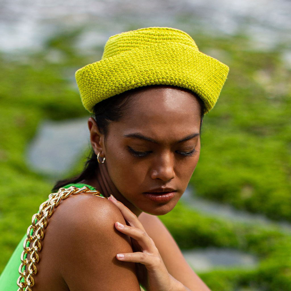 Gani hat in neon green is hand-crocheted in breathable cotton yarn by our local artisans in Java island. Featuring a modern twist of the cloche hat shape, this hat has sturdy textures and fluid proportions. Fold the brim part to shape it into a sailor hat style.