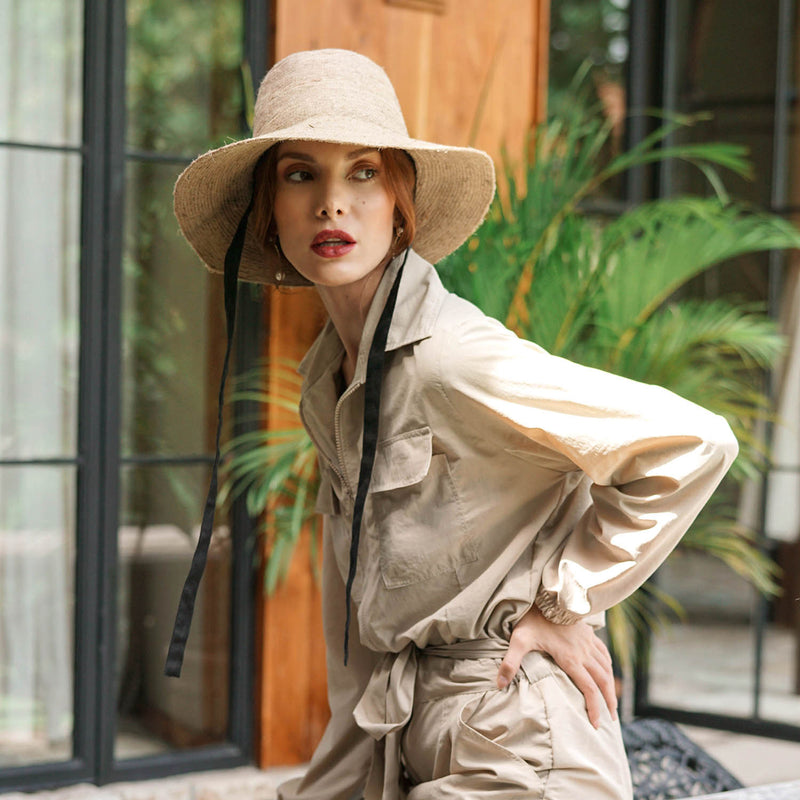 Meg Jute Straw Hat in Beige. Beautifully crafted with a tall crown shape and medium-width brim to bring back the effortless classic charm. Take this hat to your next outdoor adventure or simply to style up your daily grocery shop trips!