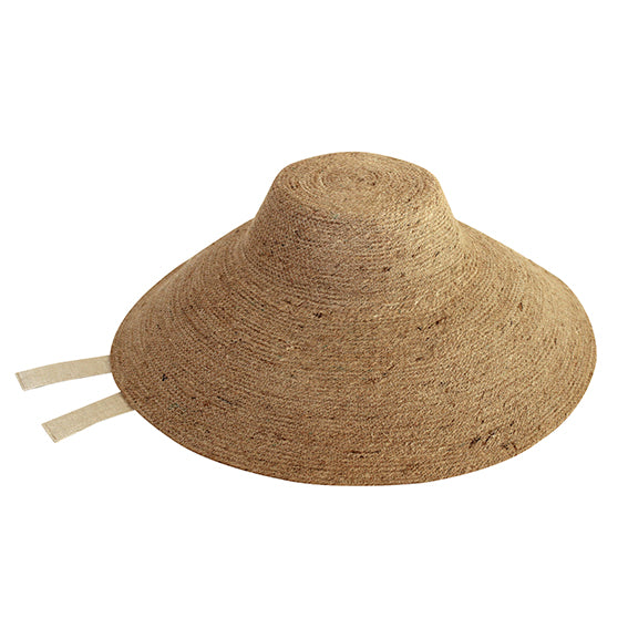 Reign Jute Straw Hat in Nude Beige. REIGN is a classic multi-functional hat with downturned brim made with natural jute straw and a modern structural shape. This hat is made to accompany you from the great outdoors to chic dinner and anywhere you travel in between.