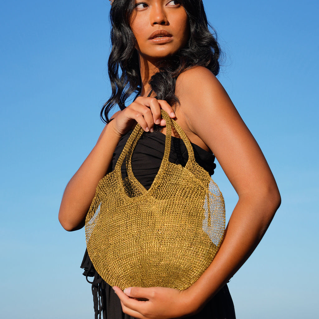 BrunnaCo Artisanan SOL Wire Tote Beach Bag in Dark Gold. Precious handwoven tote bag made from stainless metal wire. Made carefully by our artisans in remote villages in Bali, who create the bags from their very own homes. It is a true masterpiece.