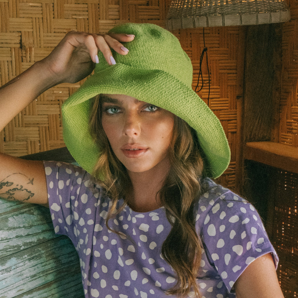 Bloom Crochet hat in Lime Green. Soft and shapeable crochet hat inspired by the classic Calla Lily flower shape. Meticulously made by artisans in the villages of Bali. Its light and semi-floppy construction make it the perfect hat for picnics at the beach or poolside any season of the year.