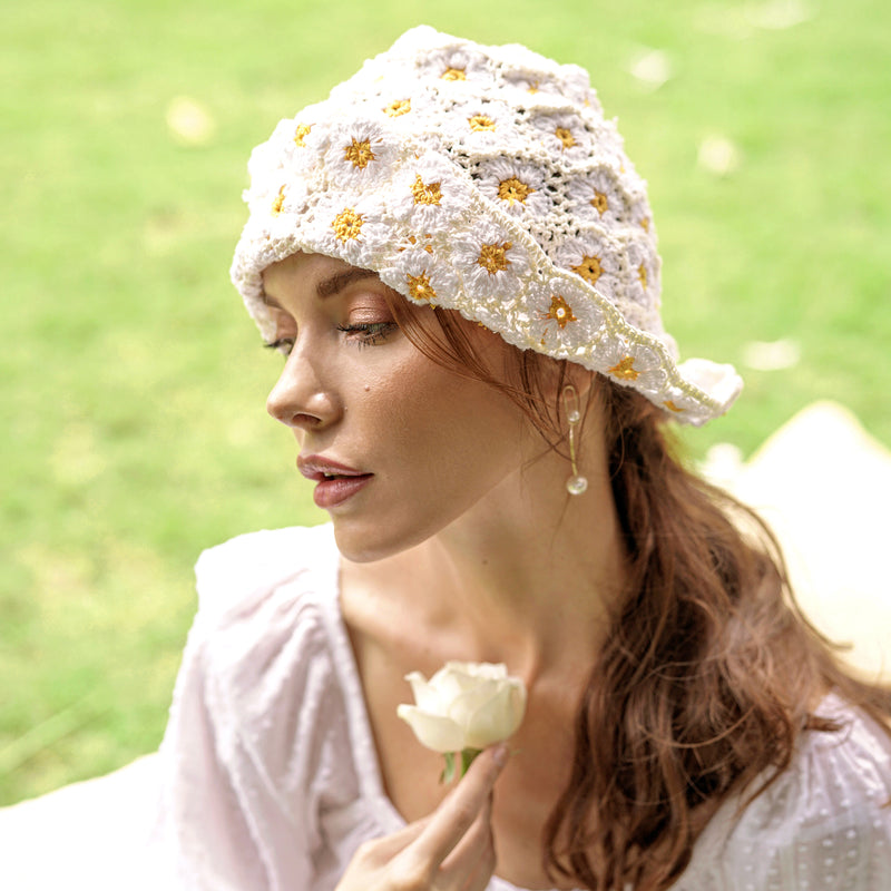 Flora Daisies Crochet Beanie Hat in Off White. This gorgeous crochet hat made from 100% cotton yarn, complete with an eye-catching flower pattern, is designed to give you a fun and feminine fit.  A must-have collection for creating a cute and casual look. Hand-crocheted with love by our female artisans from their very own home in Bali.