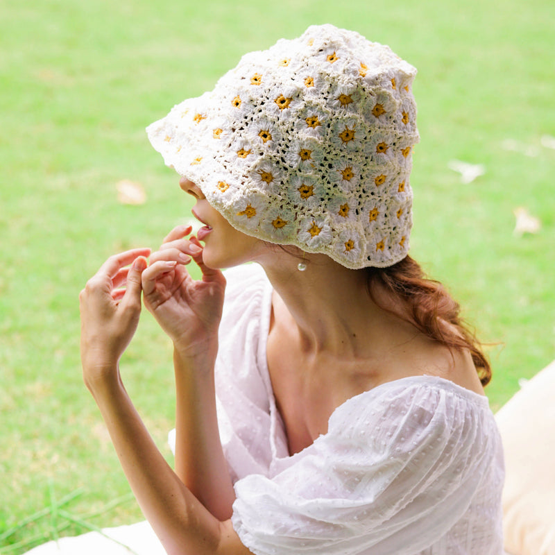 Flora Daisies Crochet Beanie Hat in Off White. This gorgeous crochet hat made from 100% cotton yarn, complete with an eye-catching flower pattern, is designed to give you a fun and feminine fit.  A must-have collection for creating a cute and casual look. Hand-crocheted with love by our female artisans from their very own home in Bali.