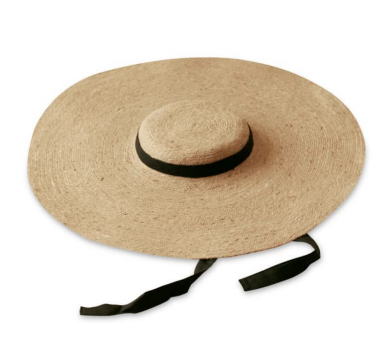 Lola Wide Brim Jute Straw Hat with Black Strap. Braided meticulously by artisans in Gianyar, Bali from natural Jute material, this sweet hat offers both comfort and elegance. Designed with ideal thickness and weight that allow its brim to be easily folded, stretched, and styled, making it easy to take to any holiday trips.