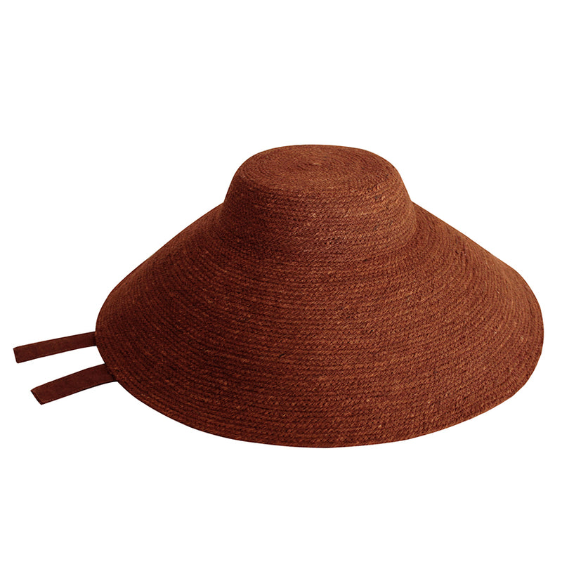 Reign Jute Beach Hat in Burnt Sienna. REIGN is a classic multi-functional hat with downturned brim made with natural jute straw and modern structural shape. This hat was made to accompany you from the great outdoors to chic dinner and anywhere you travel in between.