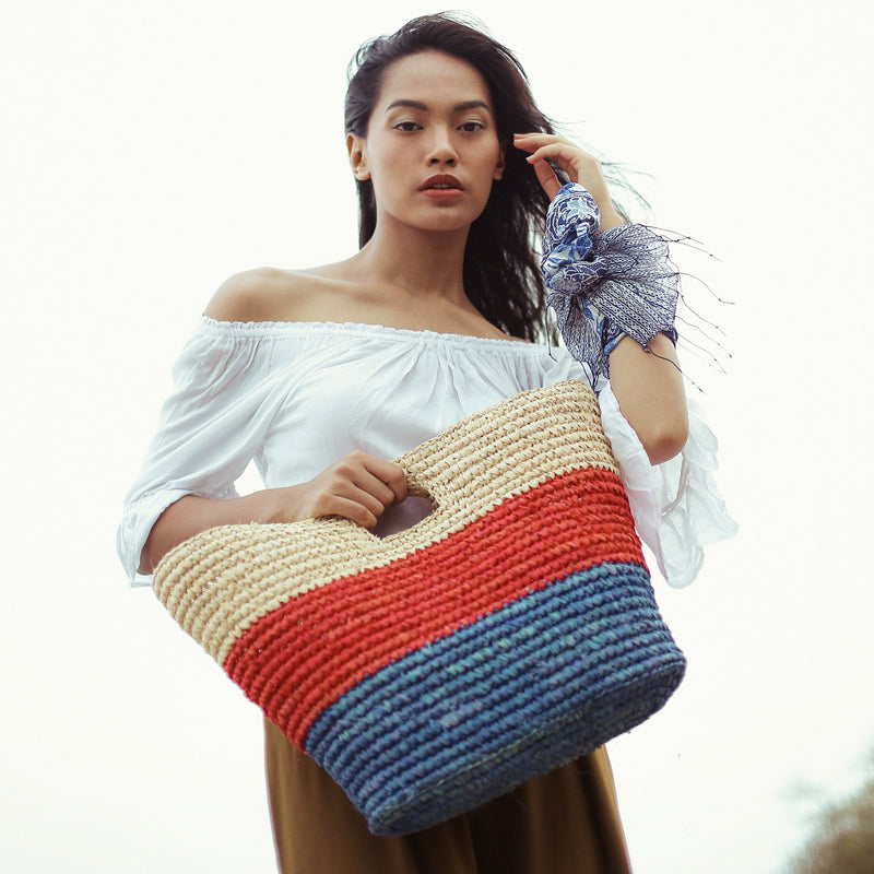 BrunnaCo Sayan Raffia Woven Straw Tote Bag in Red and Blue. A raffia beach tote that is perfect for any beach stroll or a casual walk to the nearest farmer's market