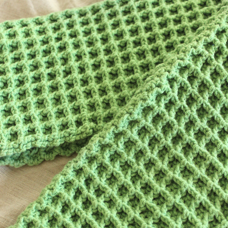 BrunnaCo's WAFFLE Crochet Scarf in sage green has a cozy and buttery-soft texture that makes you want to wear it everywhere when the temperature gets cold. It's hand-crocheted in waffle pattern with sumptuous cotton yarn by our female artisans in Java who put so much love into this piece. Wrap it around your neck twice or let it drape loosely over the lapels of your coat.