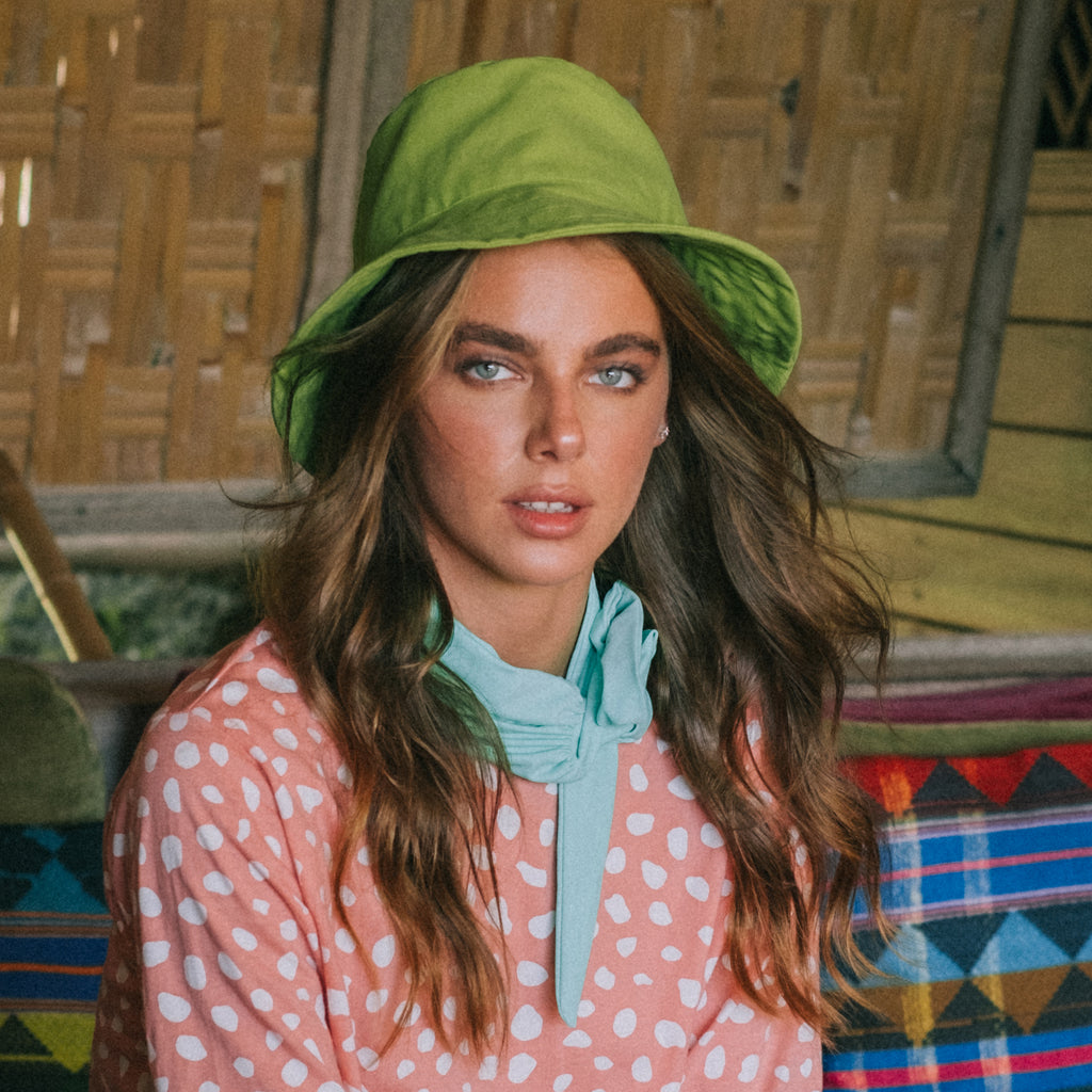 Watu Cotton Seaside Bucket Hat in Lime Green. This vibrant and casual bucket hat is ideal for those hot sunny days. Exude cool and confidence with this bucket hat, whether lounging by the poolside or taking a morning hike in nature.